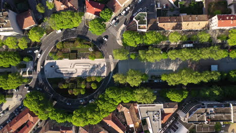 Left-to-right-aerial-traveling-over-a-roundabout-in-Nîmes-avenue-Jean-Jaurès